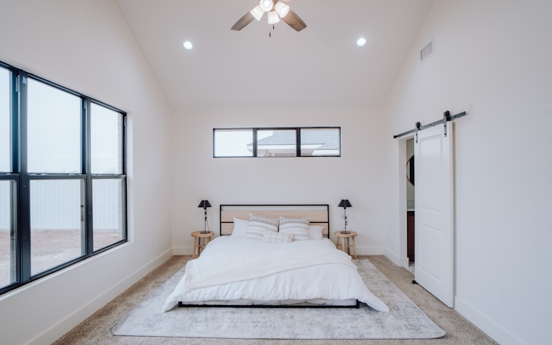Modern bedroom with ceiling fan and recessed lighting